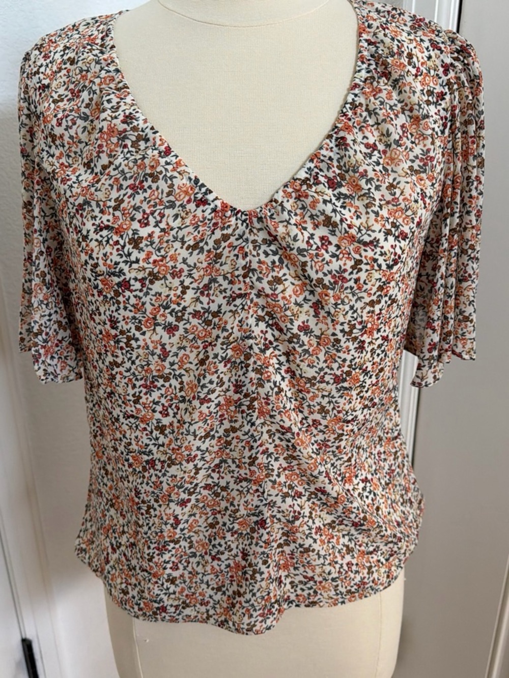 1. State Floral V-Neck Blouse in Cream with Rust & Green Motif